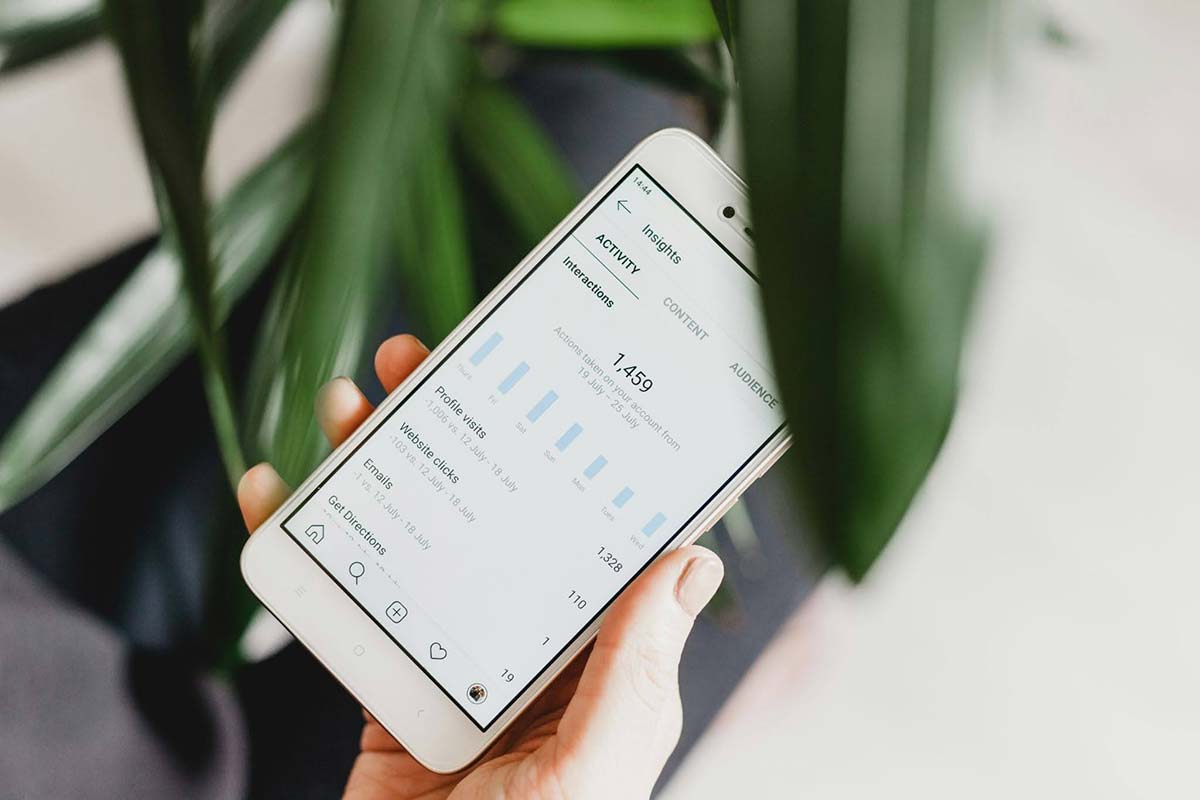Person analyzing the success of a website on a mobile device