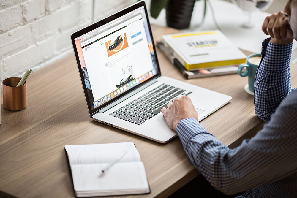 Man browsing the internet on a laptop